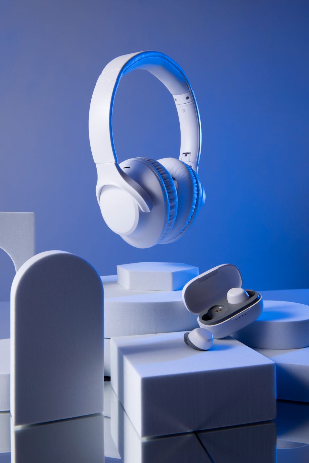 White and blue headphones floating above blue blocks